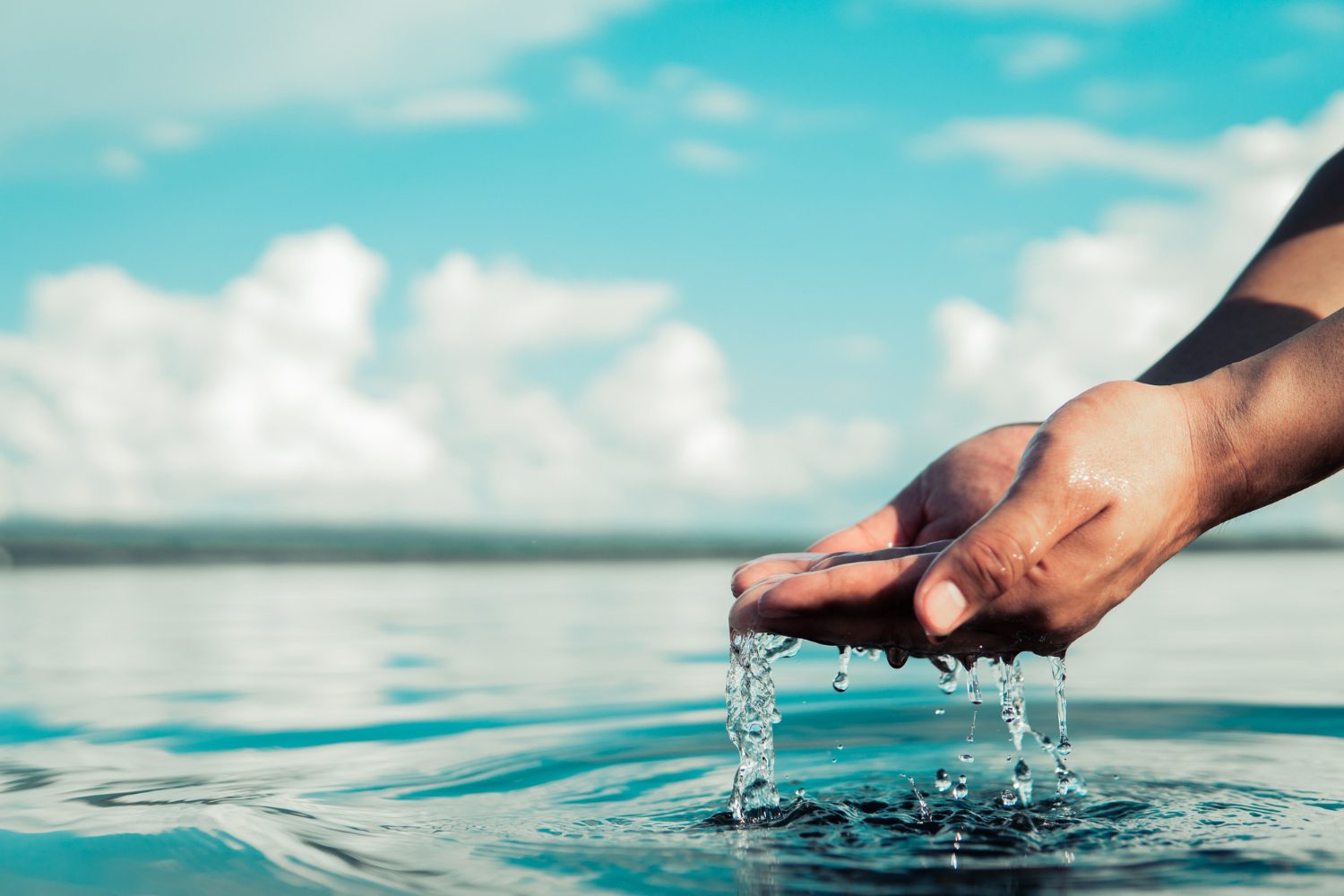 human-hand-is-touching-water-river-water-crisis